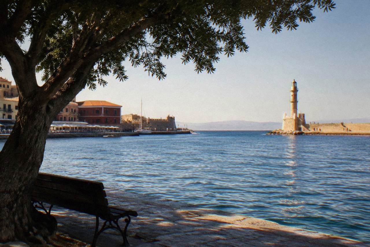 The Venetian Harbour of Chania with the lighthouse at the end of the breakwater in late afternoon light