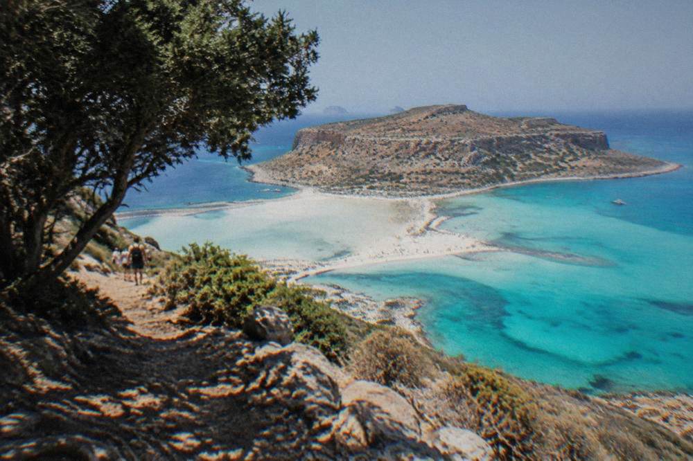 The turquoise shallows of Balos lagoon seen from the cliff path above the beach
