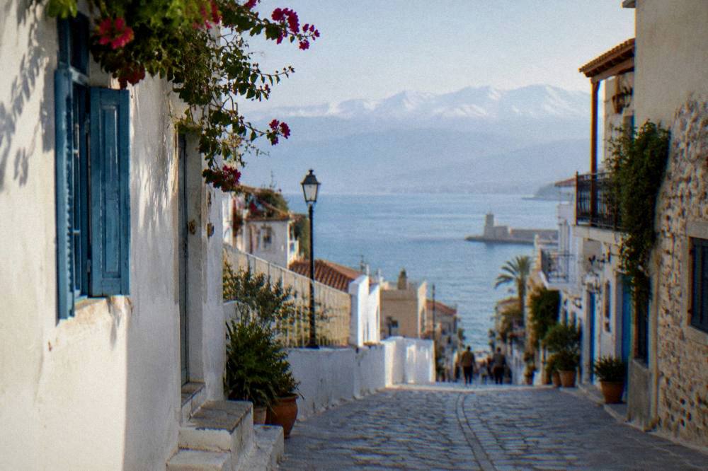 White buildings along a Chania street with the White Mountains visible in the distance