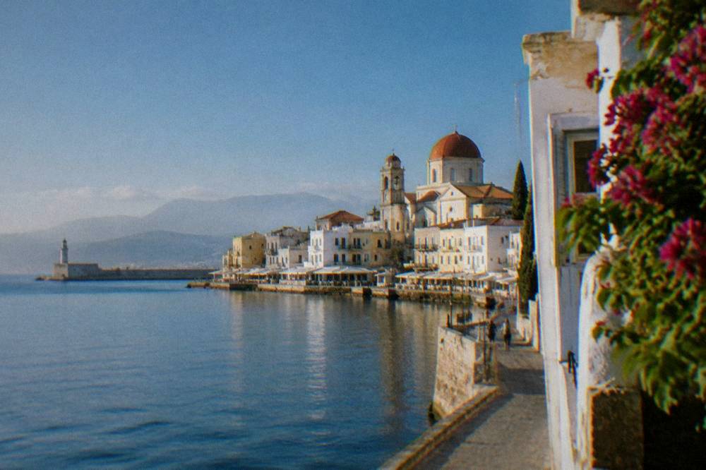 White buildings and a church dome against a deep blue sky in Chania