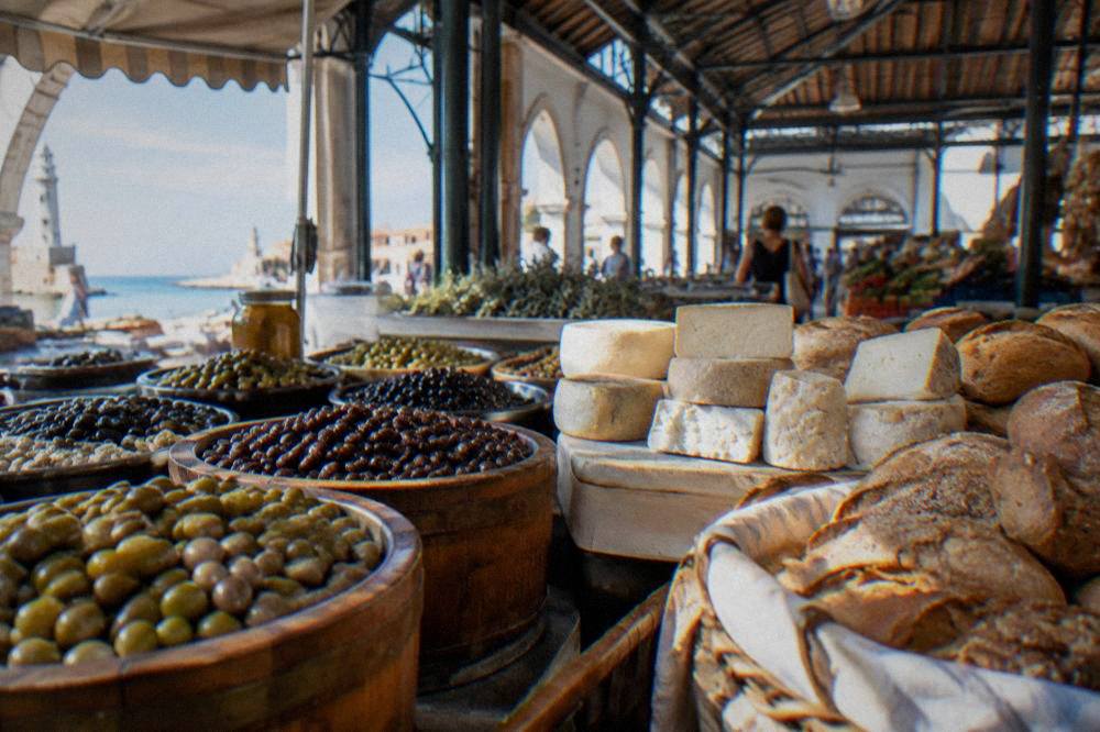A market stall with olives, cheese and bread under the roof of the Municipal Market in Chania