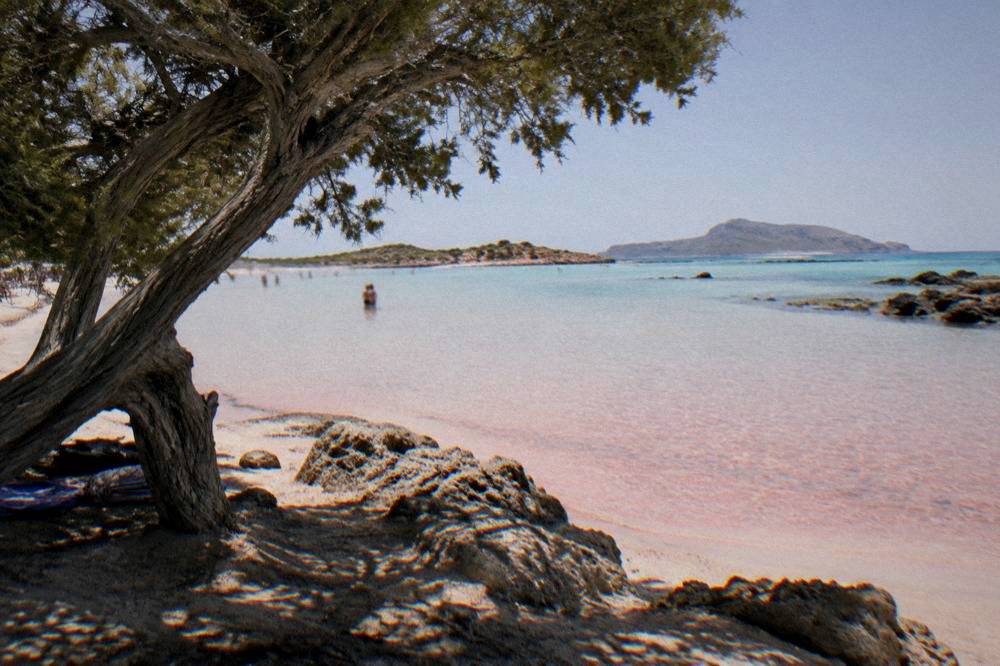 Shallow pink-tinged water and pale sand at Elafonisi beach